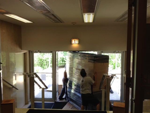 Display case being moved out the door