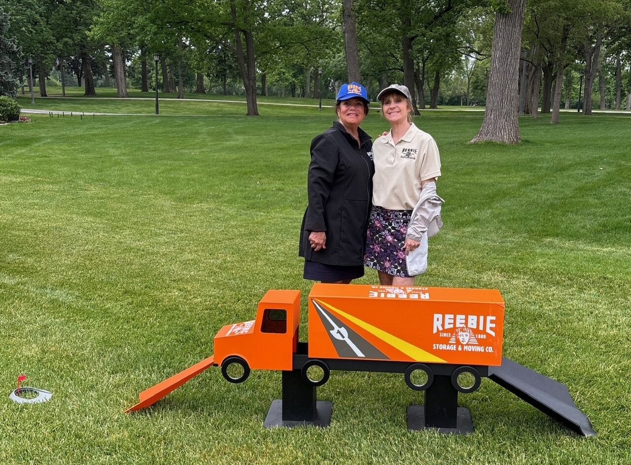 the reebie storage & moving co family pose with a reebie truck decoration